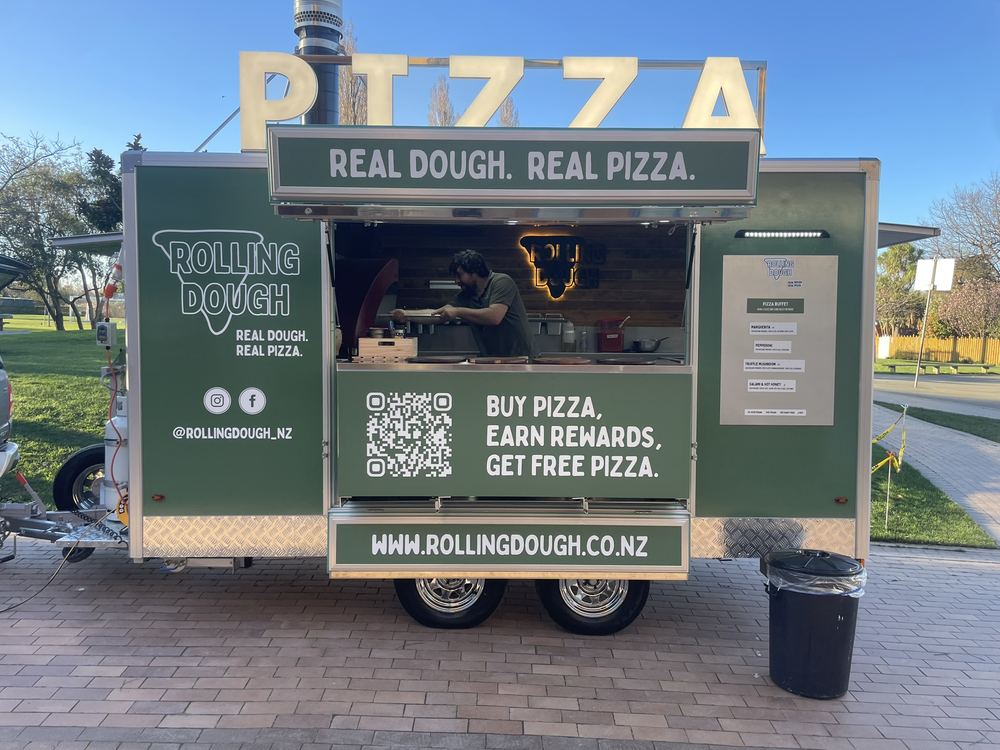 The Rolling Dough wood fired pizza trailer, hatch open and ready to serve